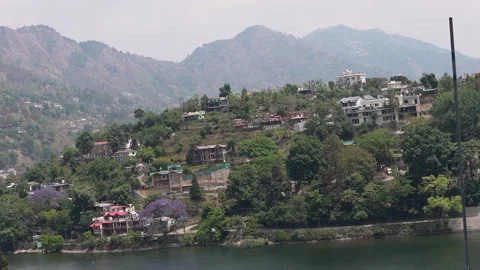 Scenic view of Bhimtal lake surrounded by hills and houses Video stock 334327698