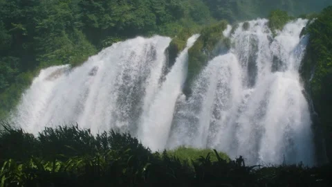 Scenic view of a big waterfall with fresh river water flowing off a cliff. Stock Footage 157435286