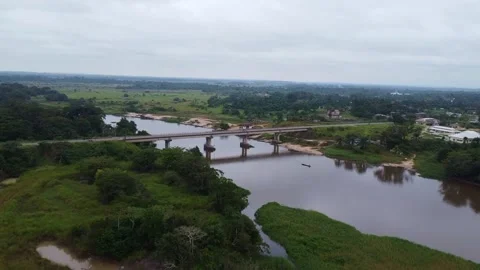 Scenic view of a bridge crossing the river surrounded by lush green vegetation Stock Footage 316465337