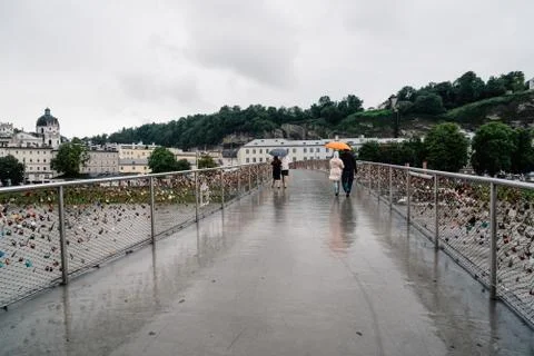 Scenic view of bridge with padlocks over river  in Salzburg Stock Photos