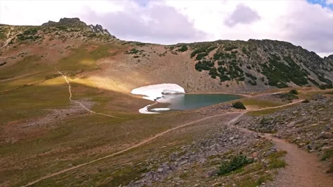 Scenic view of the Burroughs Mountain Trail and Frozen Lake in Mount Rainier Nat Stock Footage 332087665