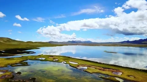 Scenic View of Calm Lake Reflecting Blue Sky and Clouds on Tibetan Plateau China Stock Footage 339513638