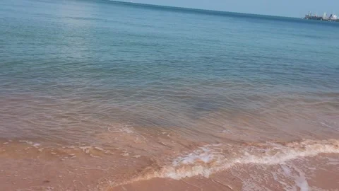 Scenic View of Calm Ocean Waves Washing Shore with City Horizon Stock Footage 341180144