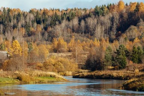 Scenic view of a calm river bending through a beautiful autumn countryside with Stock Photos