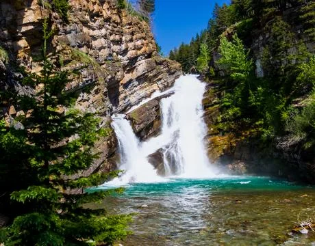 A scenic view of Cameron Falls in Waterton, Alberta on a sunny day. Stock Photos