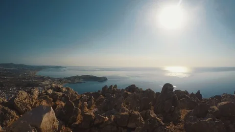 Scenic view from a cliff over looking the sea as the sun shines Stock Footage 99964641