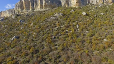 Scenic view of the cliffs with ancient caves. blue sky. forest Stock-Footage 125306001