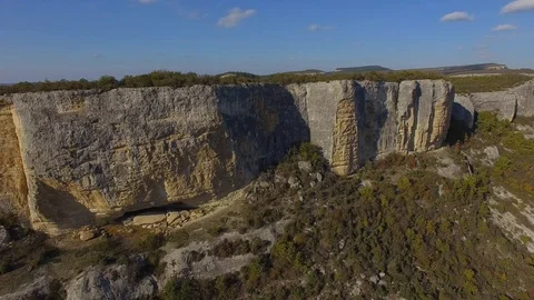 Scenic view of the cliffs with ancient caves. blue sky. forest Stock Footage 125306121