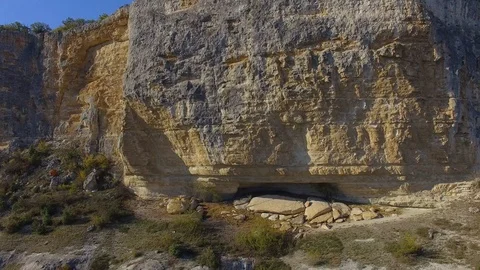 Scenic view of the cliffs with ancient caves. blue sky. forest Stock Footage 125354617