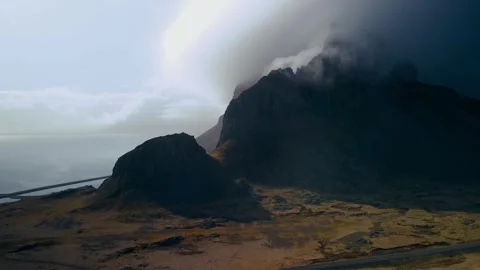 Scenic view of cloud-cover over mountains in Iceland's eastern shore line Stock Footage 279526367