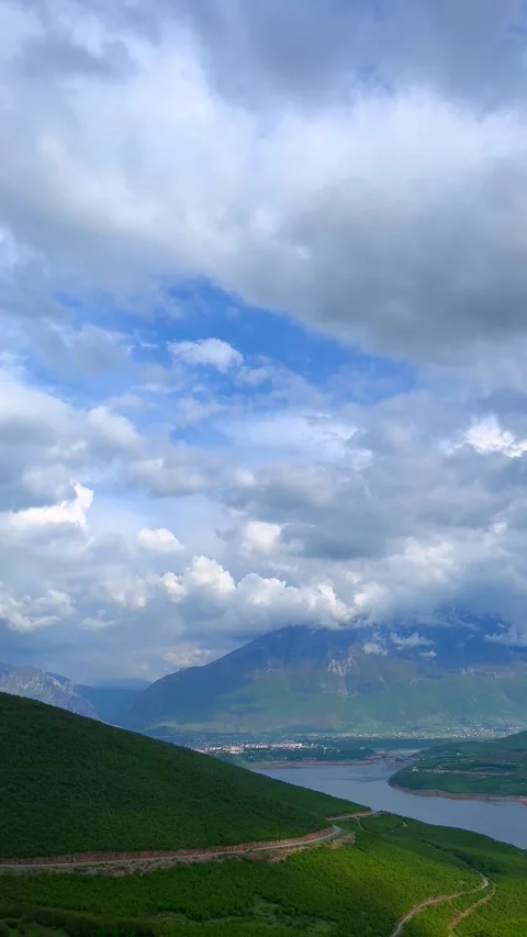 Scenic View of Cloudy Sky Over Green Mountains and Winding River Valley Stock Footage 310210161