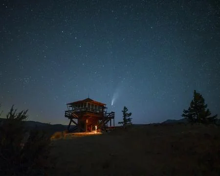 Scenic view of a comet shining on the starry sky over the landscape of Enti.. Stock Photos