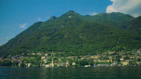 Scenic view of Como town along Lake Como with mountains and lakeside building Stock-Footage 325545532