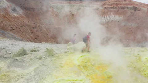 Scenic view of couple walking trough volcano sulfuric smokes, Volcano Island Stock Footage 155163661