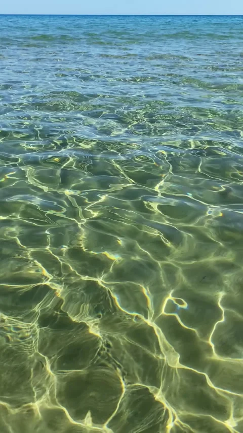 Scenic view of crystal clear turquoise sea water with sun reflections on th.. Stock Footage 336976470