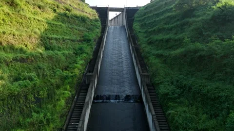 Scenic View of Dam Spillway Covered with Green Vegetation Stock Footage 309919735
