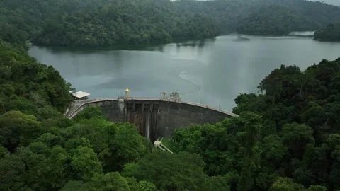Scenic View of a Dam Surrounded by Lush Green Forest and Hills Stock Footage 311575385