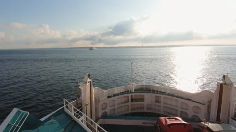 Scenic view from the deck of a ferry crossing a calm sea at sunset Stock Footage 285371014