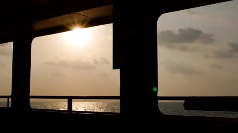 Scenic view from the deck of a ferry crossing a calm sea at sunset. Stock Footage 314223831