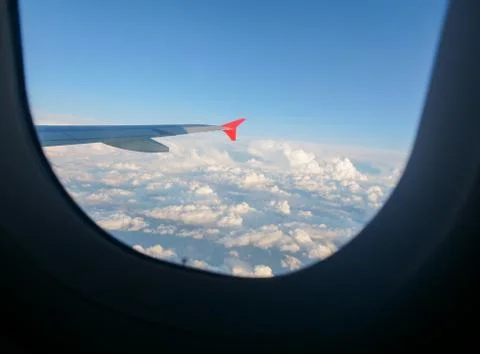 Scenic View Of Dramatic Sky clouds During Sunset, from plain window Stock Photos