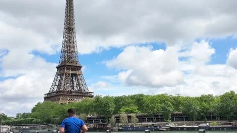 Scenic View of Eiffel Tower in Paris with Man Walking Past Stock Footage 335498415
