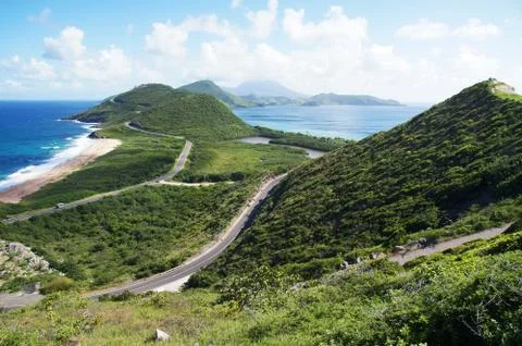 Scenic view from elevated overlook towards St. Kitts isthmus and Nevis Island Stock Photos