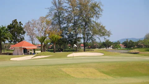 Scenic view of empty golf course with vibrant green fairways, sands Видео 272475890