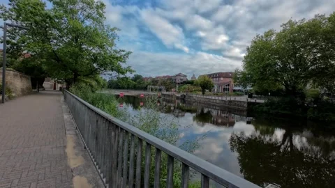 Scenic view of the Ems River promenade in Rheine, Germany, with lush green .. Stockbeeldmateriaal 346297410