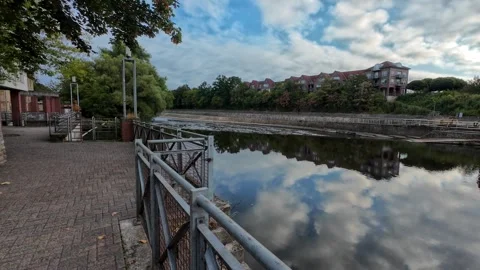Scenic view of the Ems River promenade in Rheine, Germany, with lush green .. Stockbeeldmateriaal 346297568