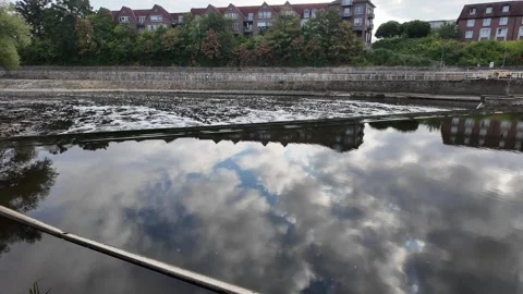 Scenic view of the Ems River promenade in Rheine, Germany, with lush green .. Stockbeeldmateriaal 346297623