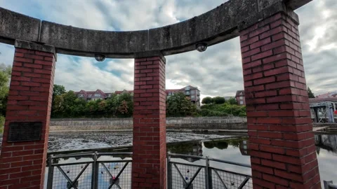 Scenic view of the Ems River promenade in Rheine, Germany, with lush green .. Stockbeeldmateriaal 346297778