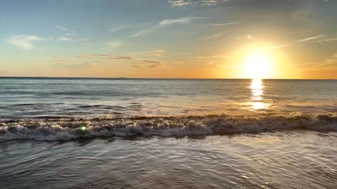 Scenic View of Gentle Sea Waves Rolling on the Beach Under Golden Sunset Stock Footage 345953802