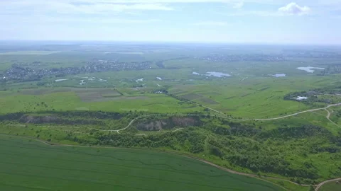 Scenic view of the green plain with fields, groves, lakes and ravines from a Stock Footage 91777968