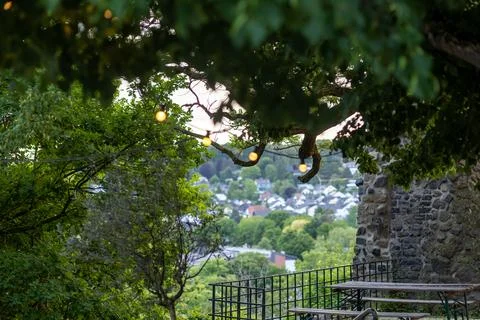 Scenic view from a hillside with string lights and a charming town beneath at Stock Photos
