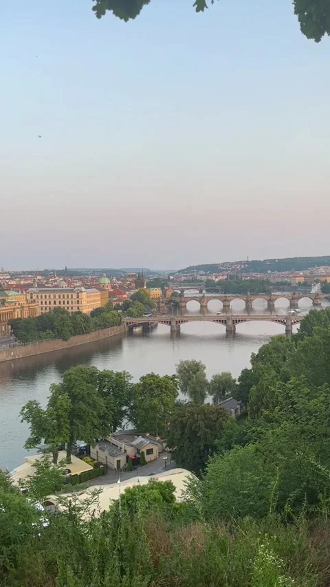 Scenic view of a historic bridge spanning a river, surrounded by lush greenery Stock Footage 311830588