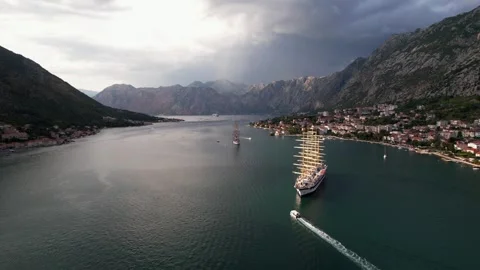 Scenic view of Kotor Bay featuring picturesque sailing ship and mountains Stock Footage 320746415