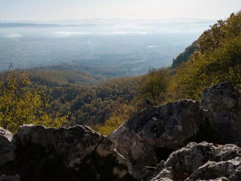 Scenic view from Kozara mountain to the valley filled with fog and smoke Stock Photos