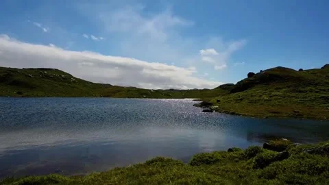 Scenic view of a lake surrounded by hills in Norway during daytime with blu.. Stock Footage 340201985