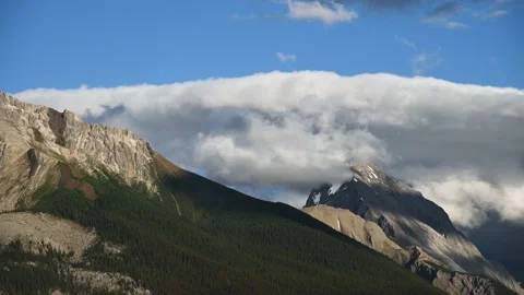 Scenic view of a large rocky mountain with blue sky in the background Stock Footage 142528542