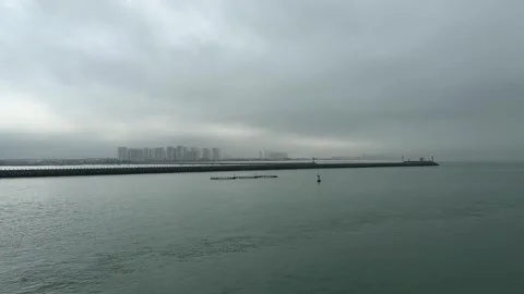 Scenic View of Lighthouse and Haikou City Skyline from Sea 4K 库存影片 331968751