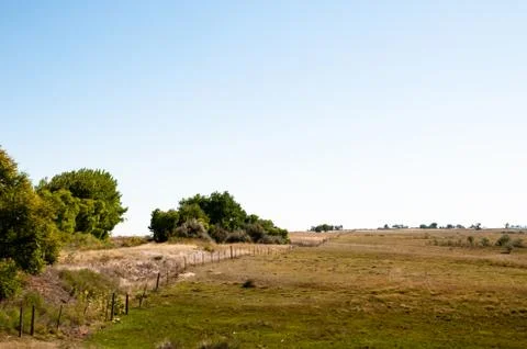 Scenic view looking down a long fence line in Colorado Stock Photos