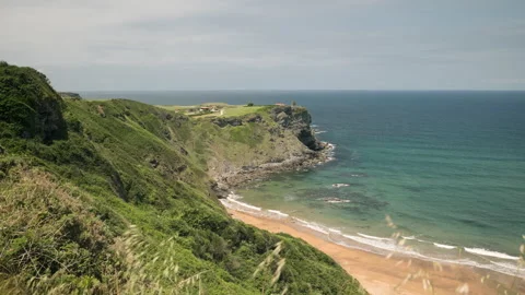 Scenic view of the lush green cliffs of Asturias with a secluded beach Stock Footage 341508424