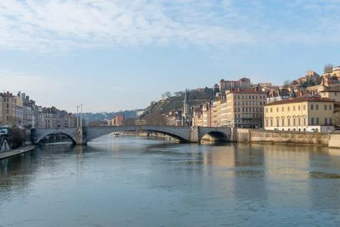 Scenic view of Lyon's historic riverfront buildings and bridge on a bright da Stock Photos
