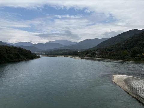 Scenic View of Min River with Distant Mountains in Dujiangyan Stock Photos