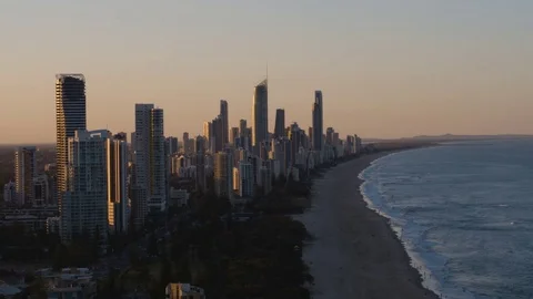 Scenic view of modern skyscrapers along the sea coast at sunset Stock Footage 80996033