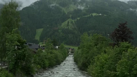 Scenic view of a mountain stream flowing through a lush alpine valley Vidéo 281536380