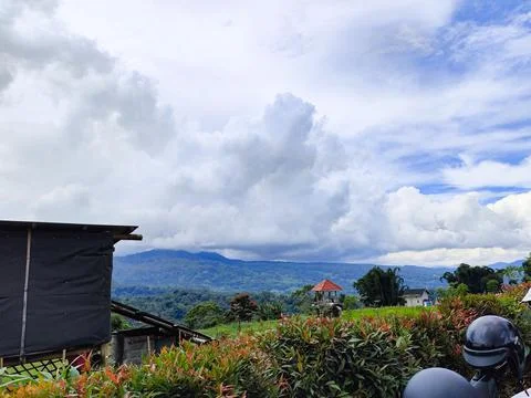 Scenic view of mountains under a dramatic sky with cumulus clouds, surrounded by Stock Photos