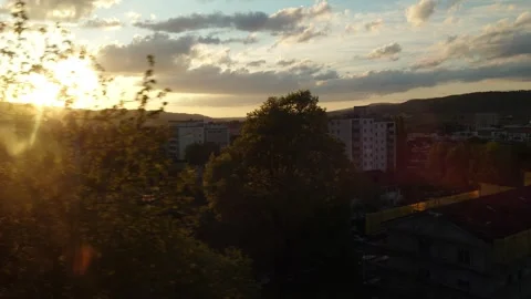 Scenic view from a moving train window looking at a suburban town sunset Stock Footage 340755801