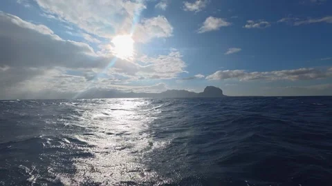 Scenic view of the ocean with Le Morne Brabant mountain in the background Stock Footage 340635296
