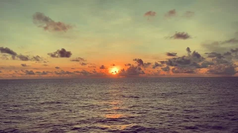 Scenic view of ocean at sunset with vibrant sky and clouds reflecting on wa.. Stock Footage 338282636